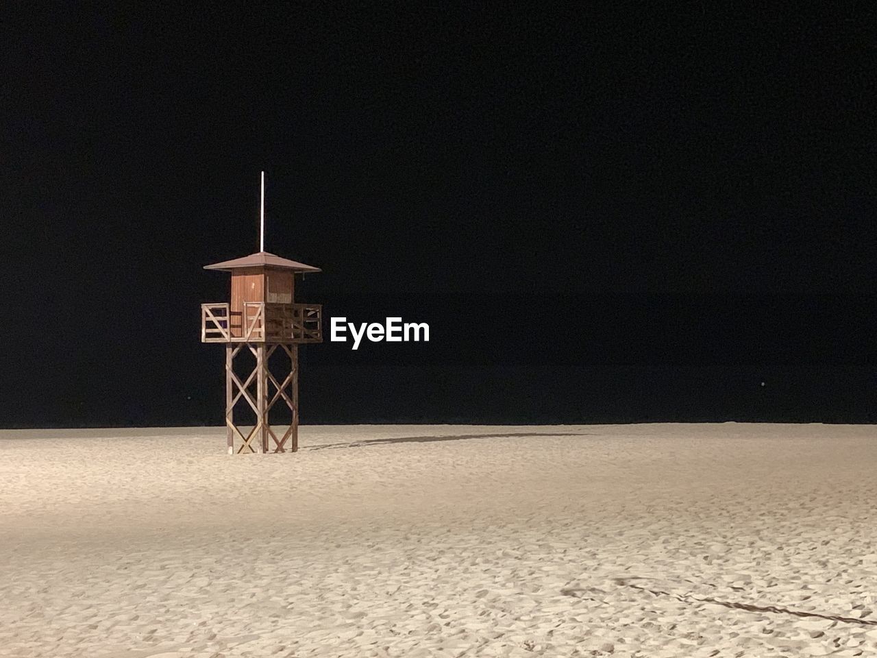 BUILT STRUCTURE ON BEACH AGAINST SKY