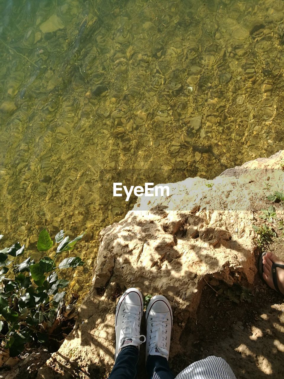 Low section of person standing on rock