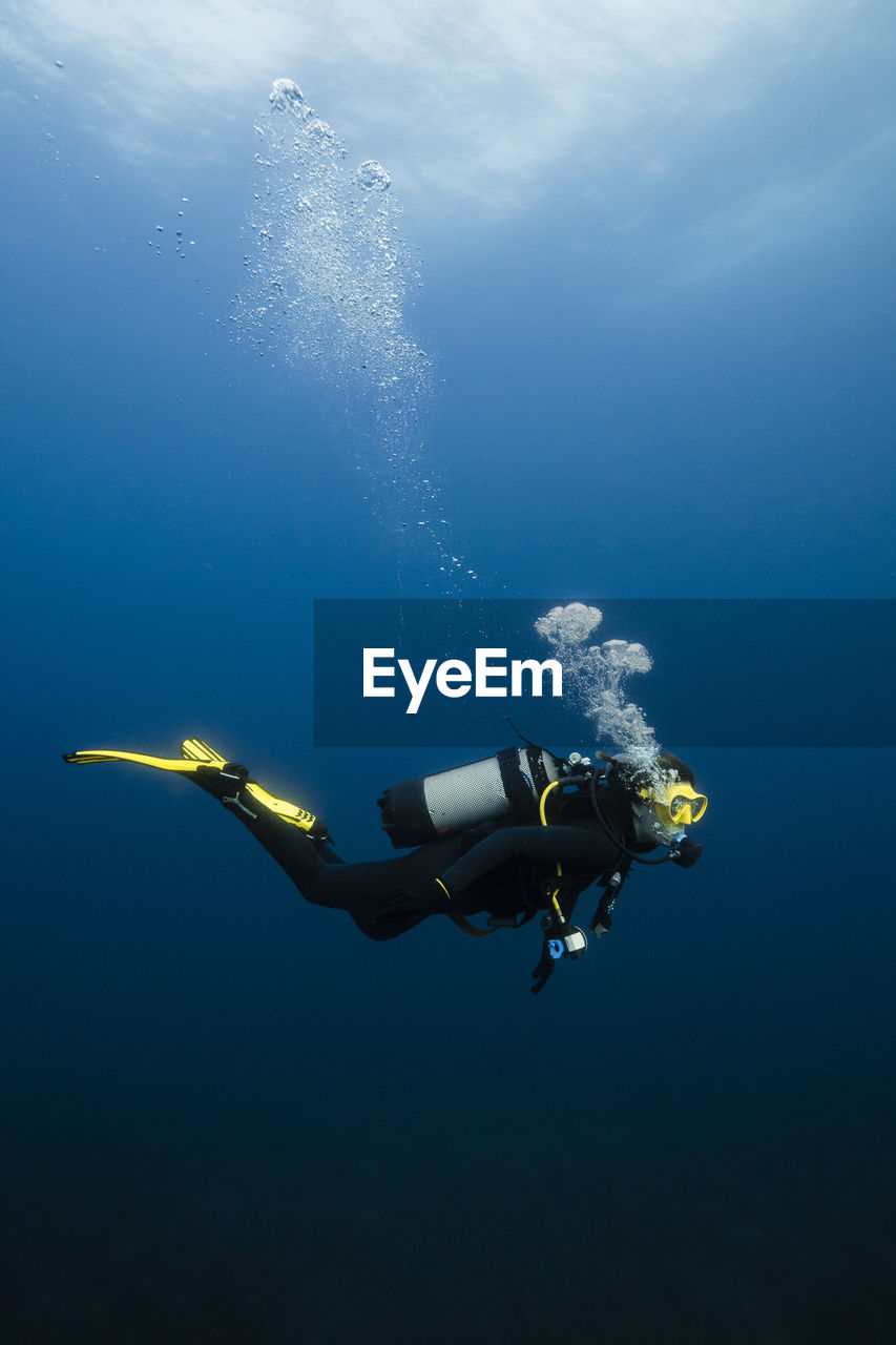 Young woman scuba diving in sea