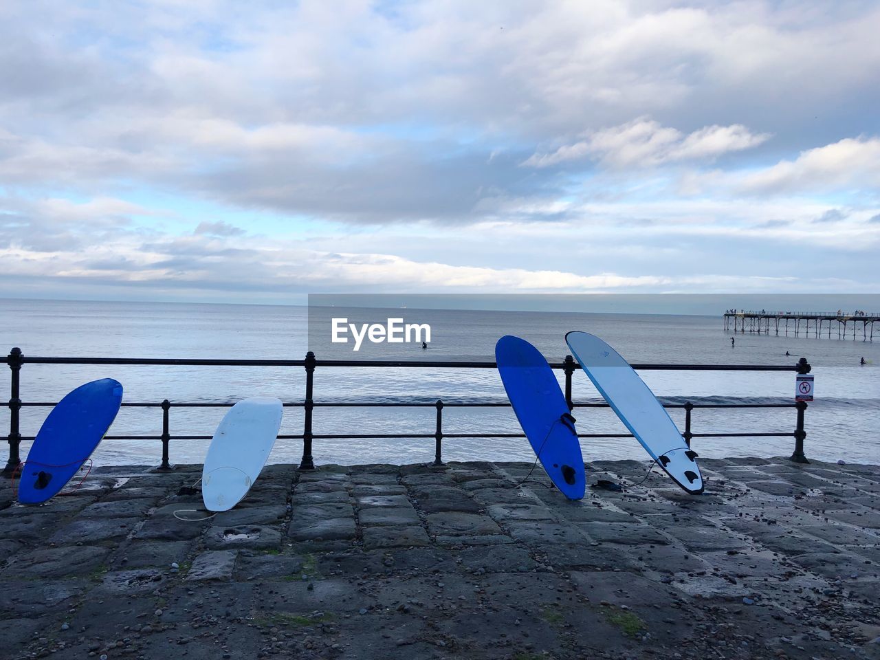 Surf boards on beach against sky in saltburn