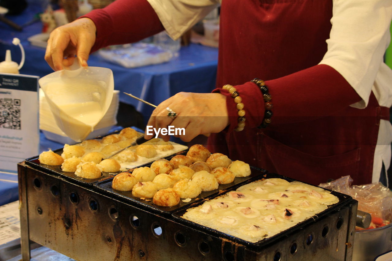 Midsection of man preparing food