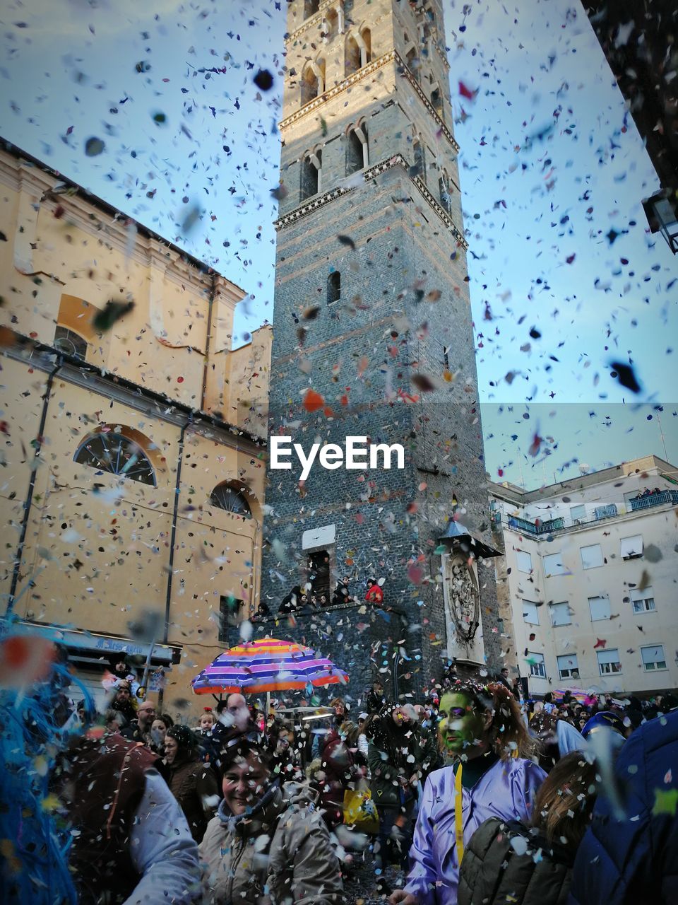 GROUP OF PEOPLE ON STREET AGAINST BUILDINGS