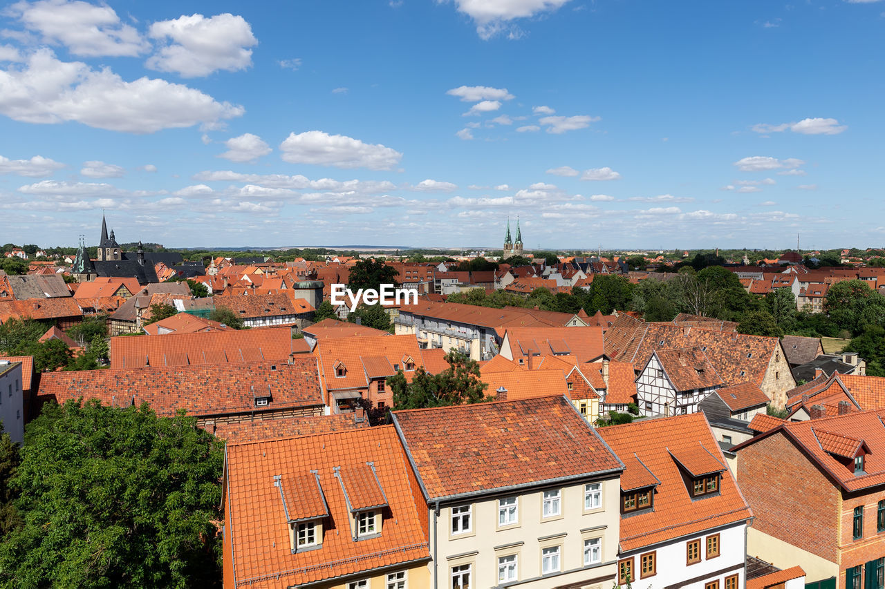 high angle view of buildings in town against sky
