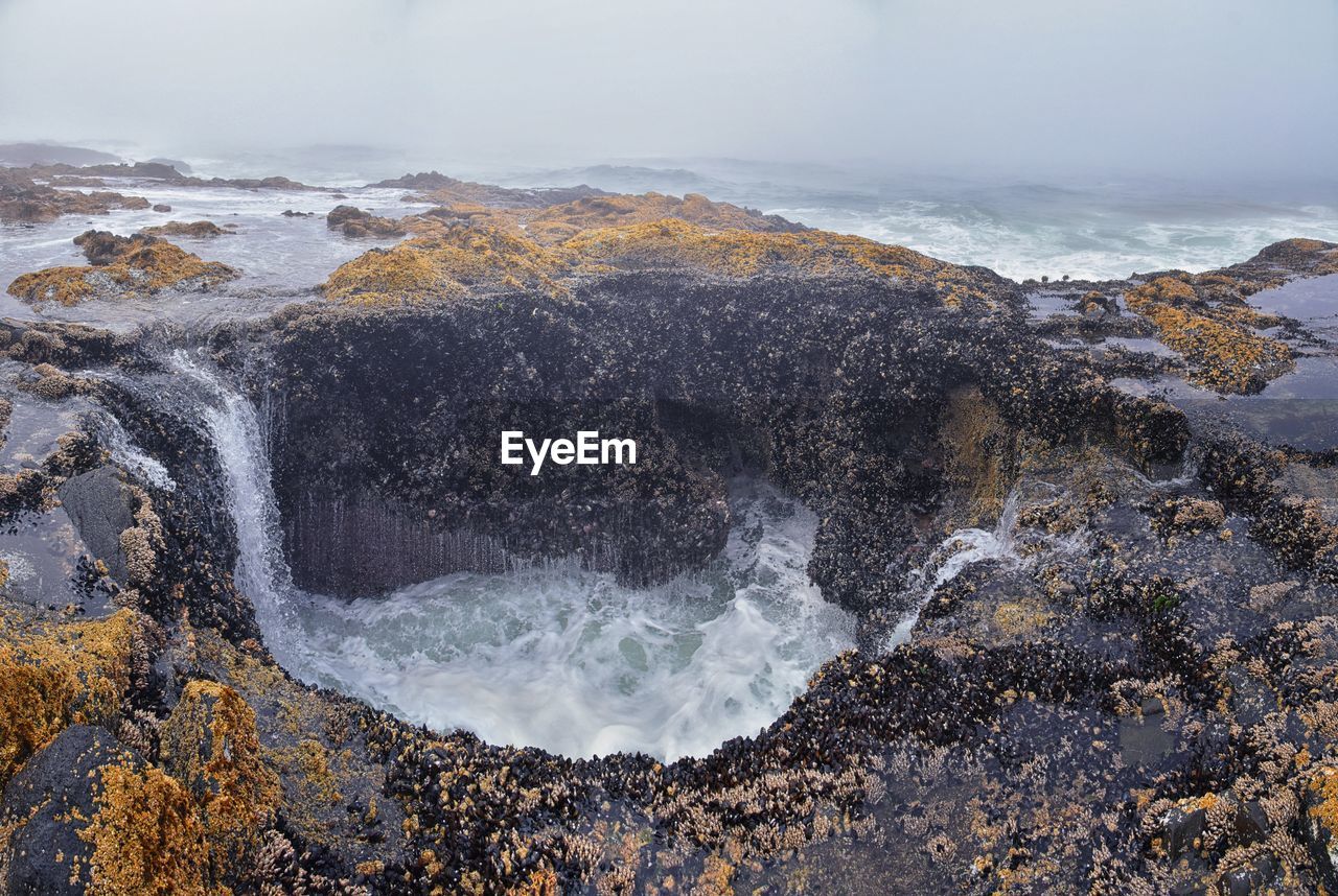 water, sea, rock, beauty in nature, nature, scenics - nature, land, wave, coast, shore, motion, body of water, environment, beach, ocean, sky, no people, water sports, sports, landscape, travel destinations, outdoors, wind wave, power in nature, non-urban scene, cliff, winter, travel, cloud, day, tourism, splashing, waterfall, mountain, tranquility
