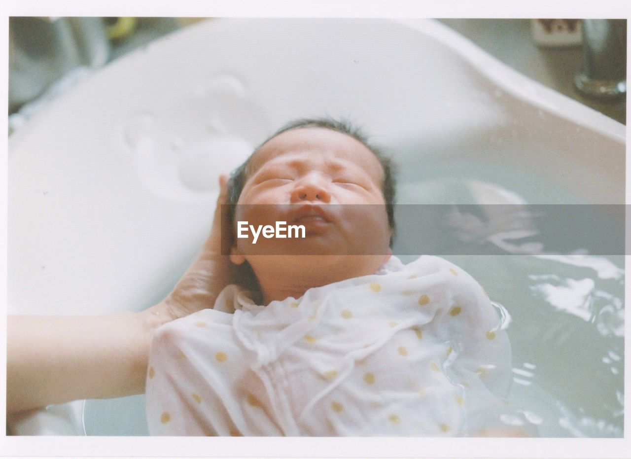 PORTRAIT OF BABY BOY IN THE BATHROOM