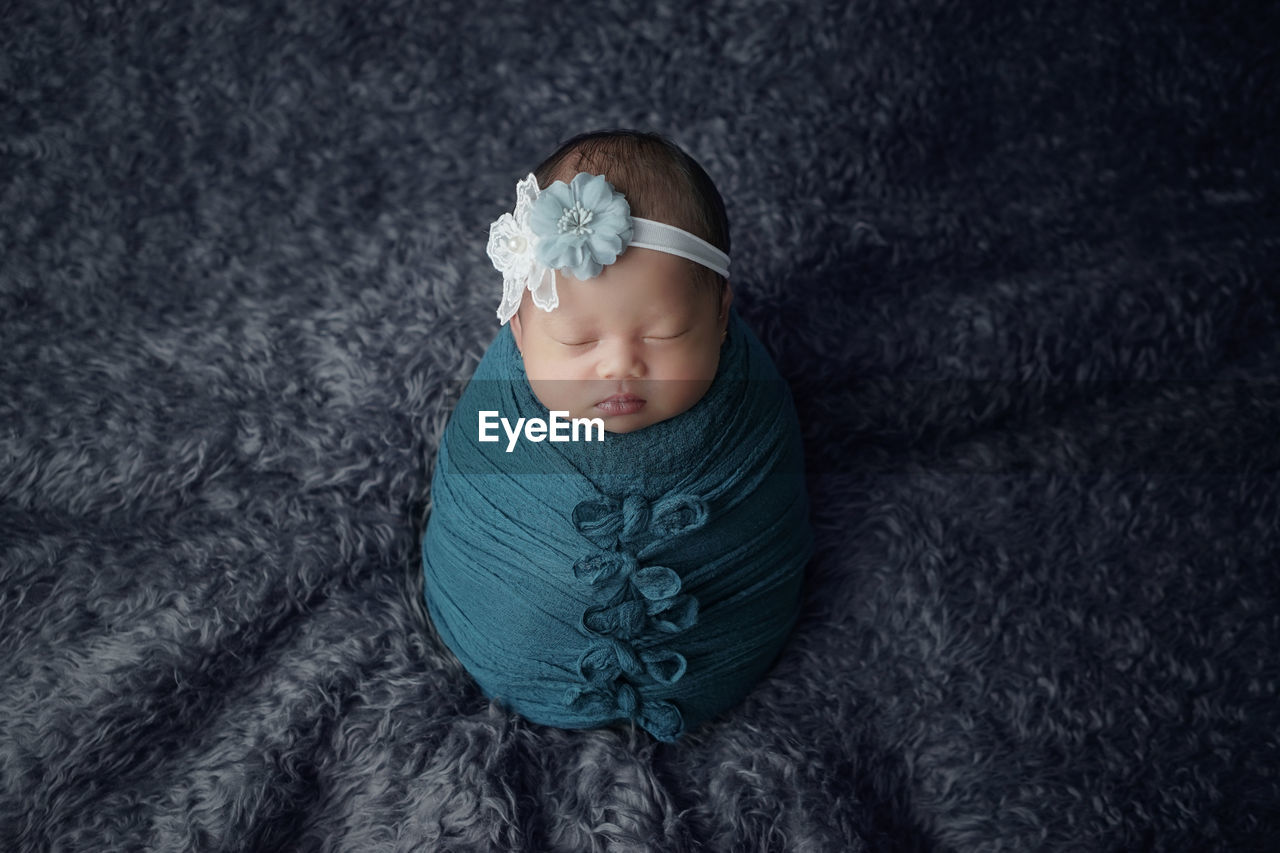 High angle view of cute baby girl sleeping