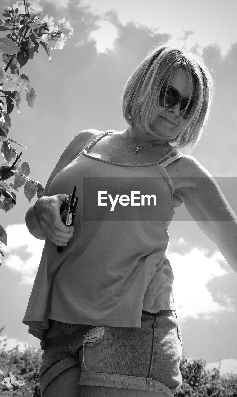 Low angle view of woman standing against sky