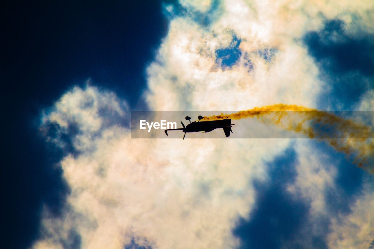 LOW ANGLE VIEW OF AIRPLANE FLYING IN SKY