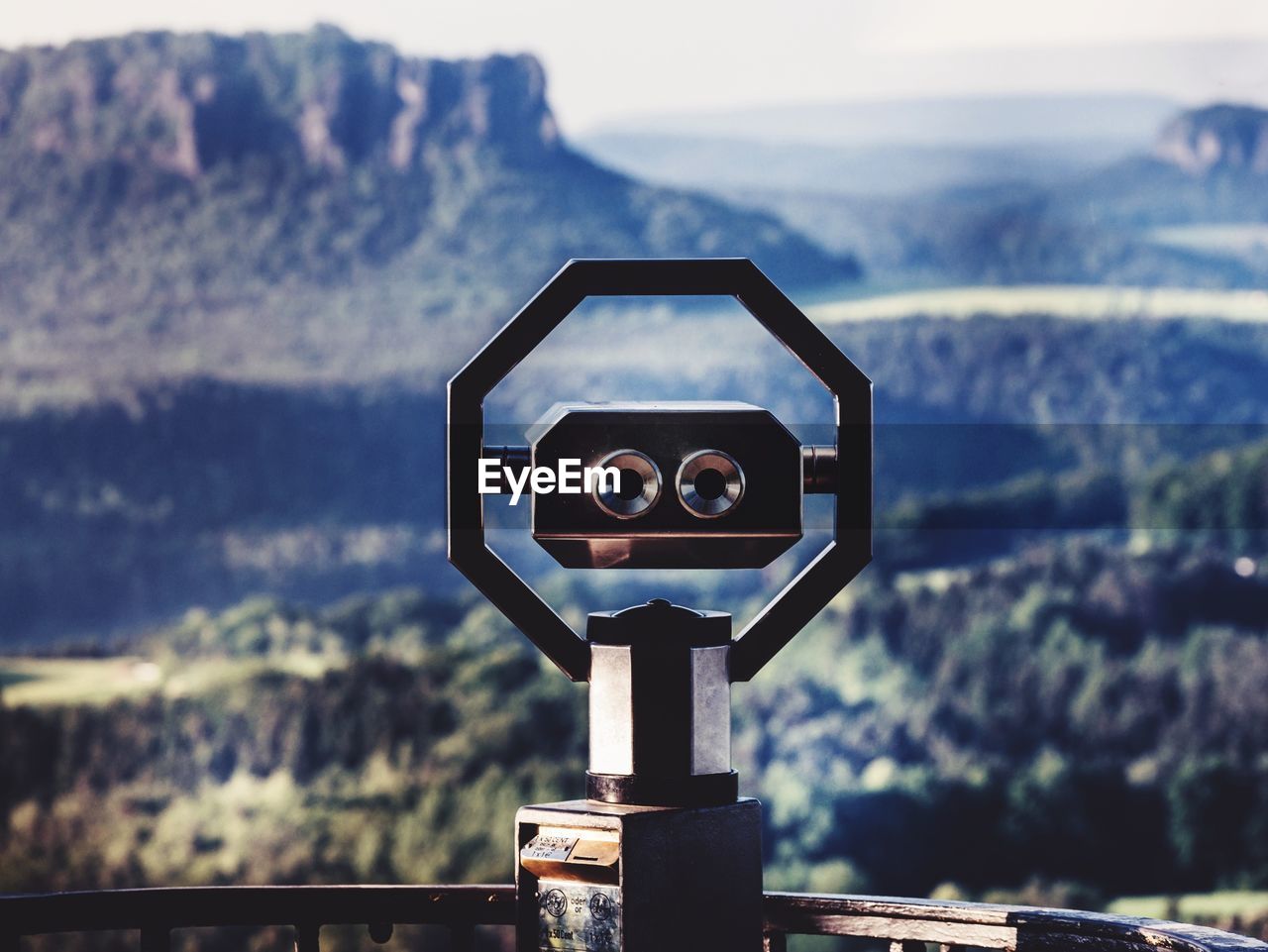 Close-up of coin-operated binoculars against sky