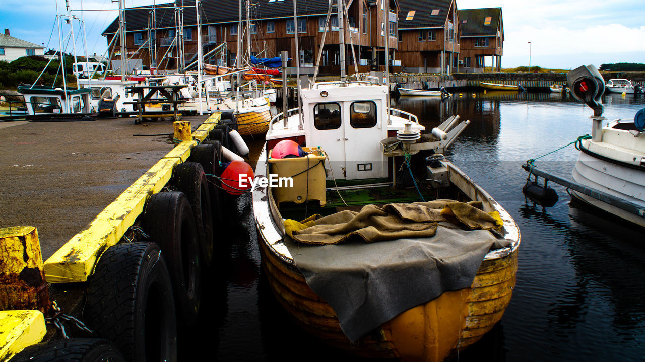 BOATS MOORED IN HARBOR