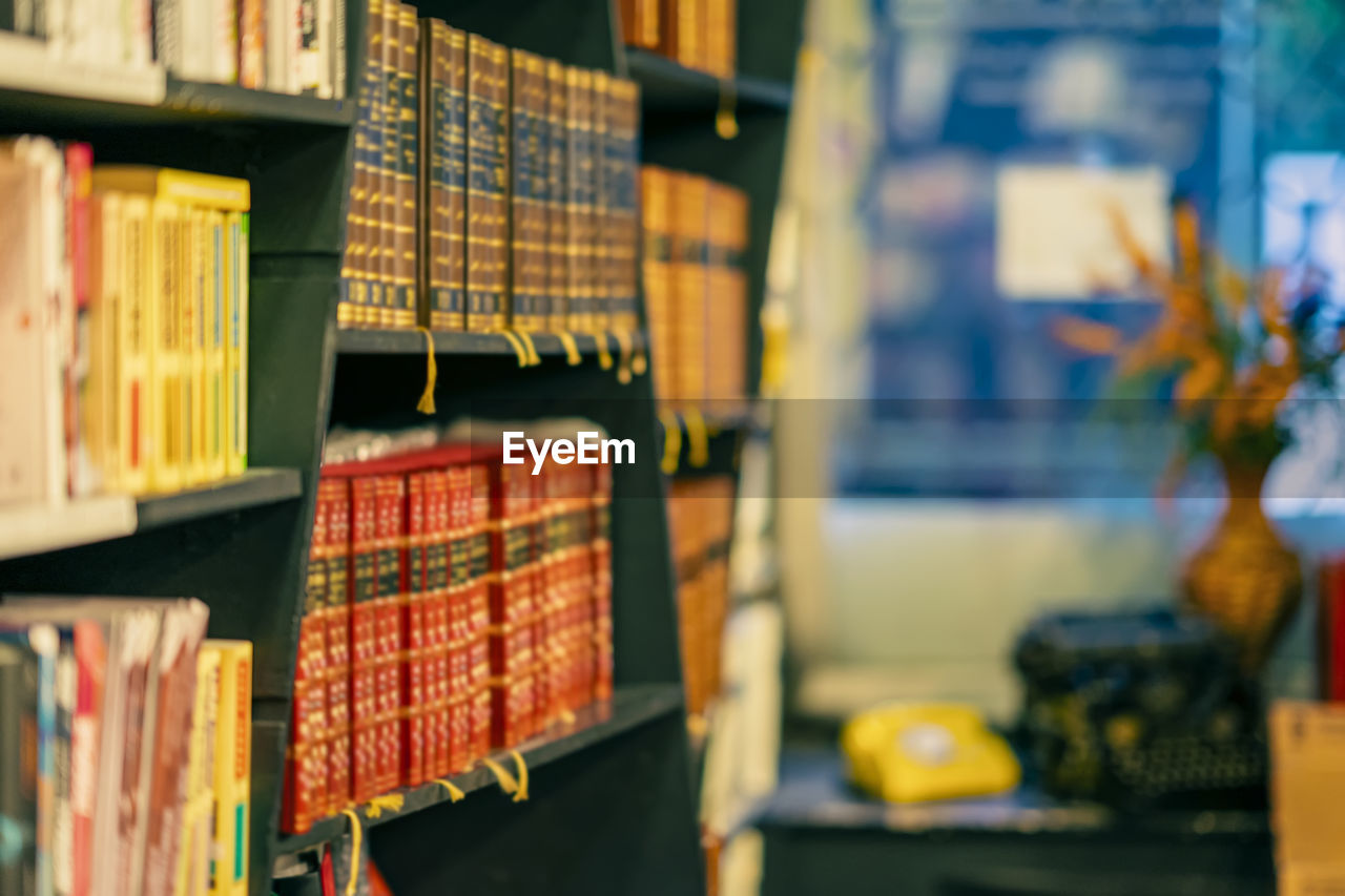 Row of books in shelf for sale