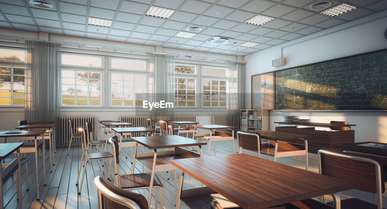 Empty chairs and tables in classroom