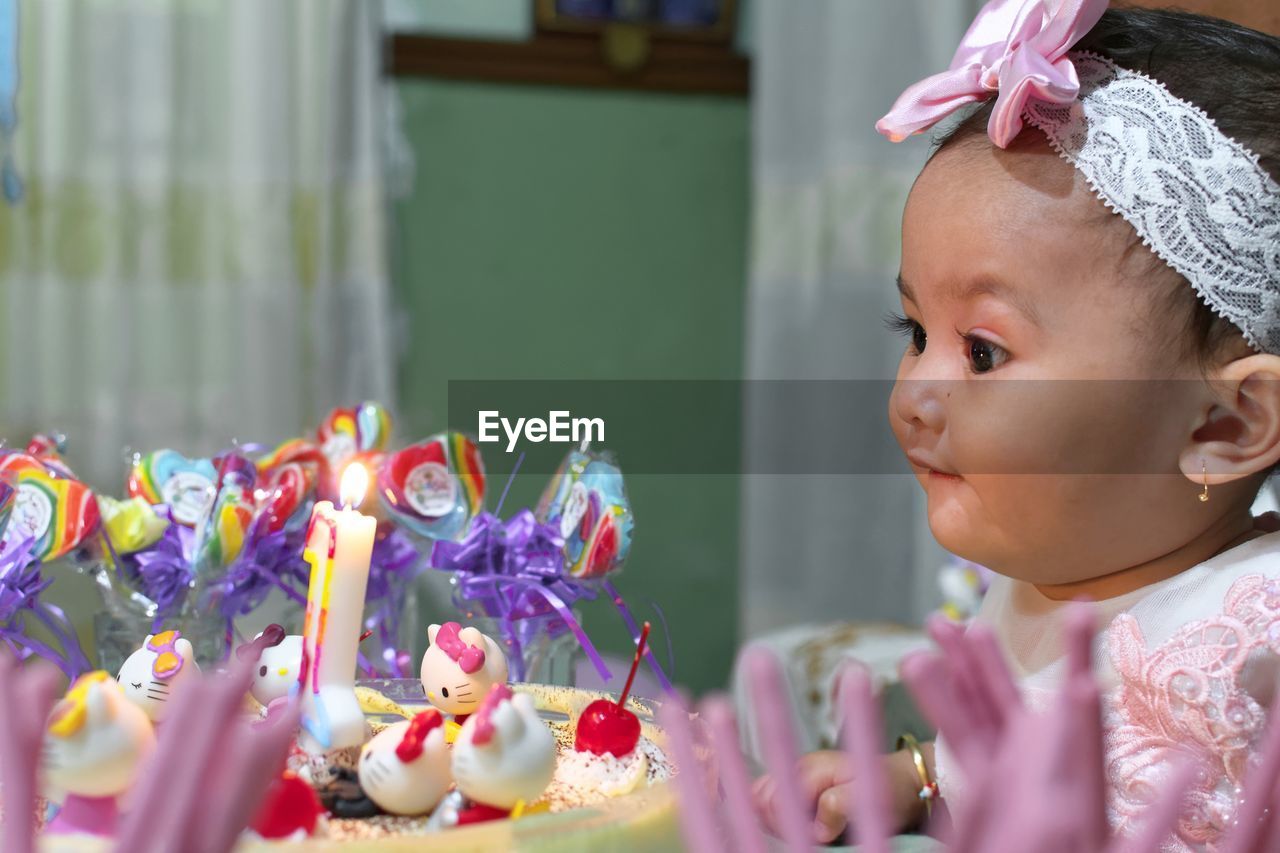 Close-up of cute baby girl during birthday party