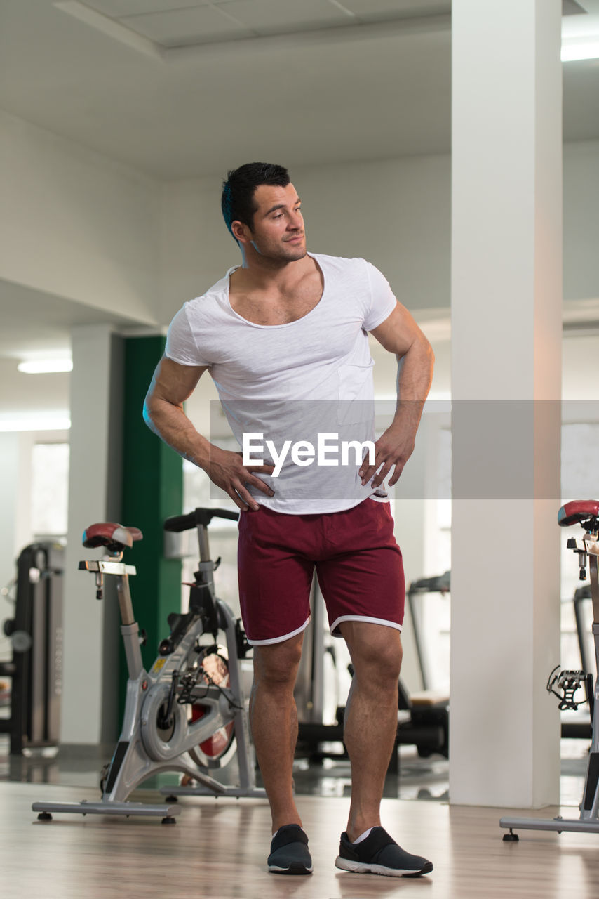 Muscular man standing in gym