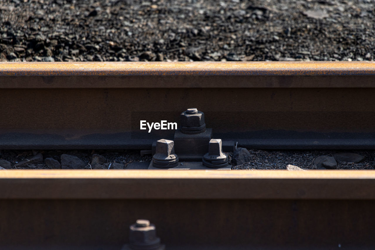 Kpo clip rail fastening system and rusty steel railway at a narrow gauge train station in germany