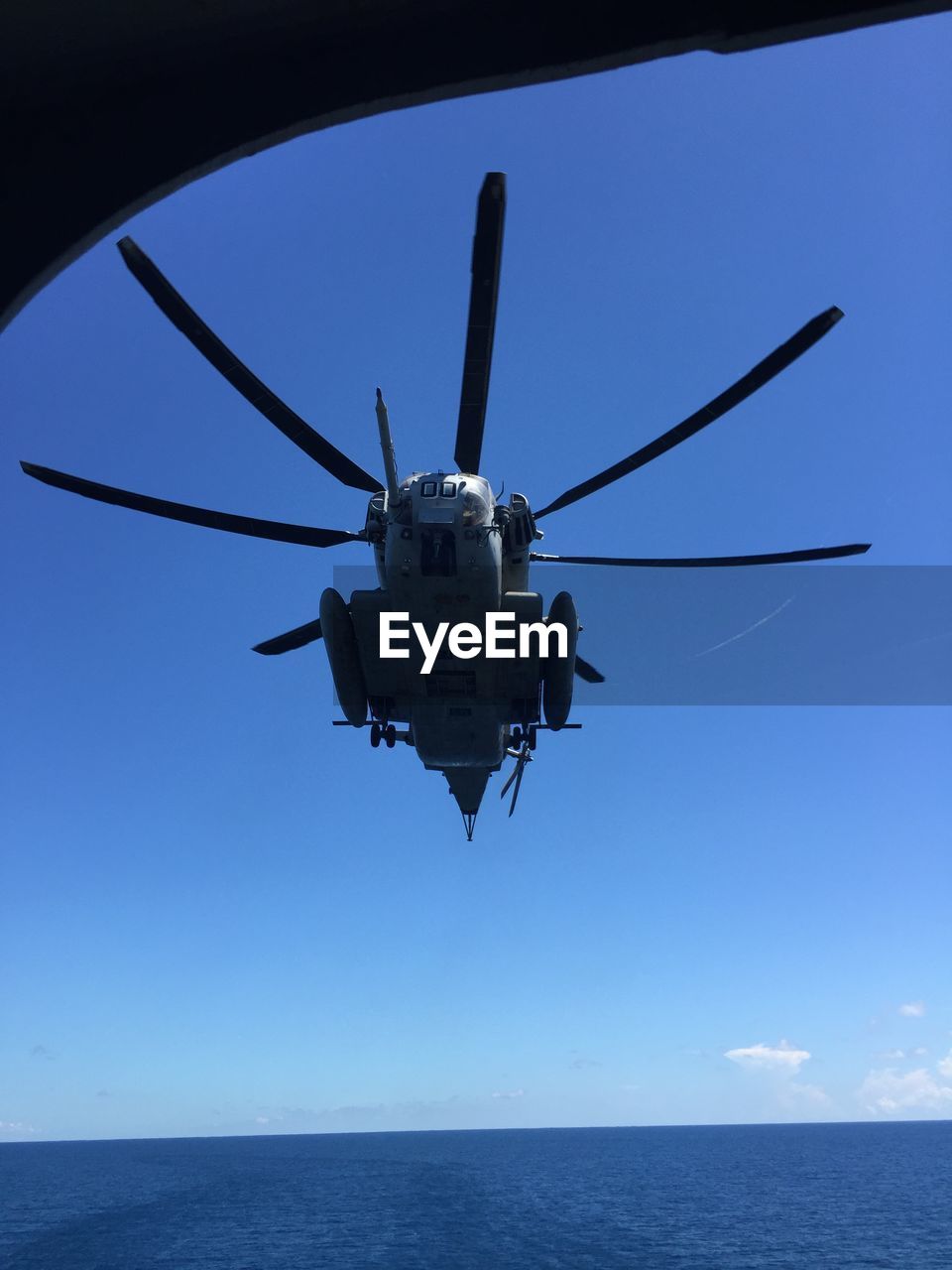 LOW ANGLE VIEW OF AIRPLANE OVER SEA