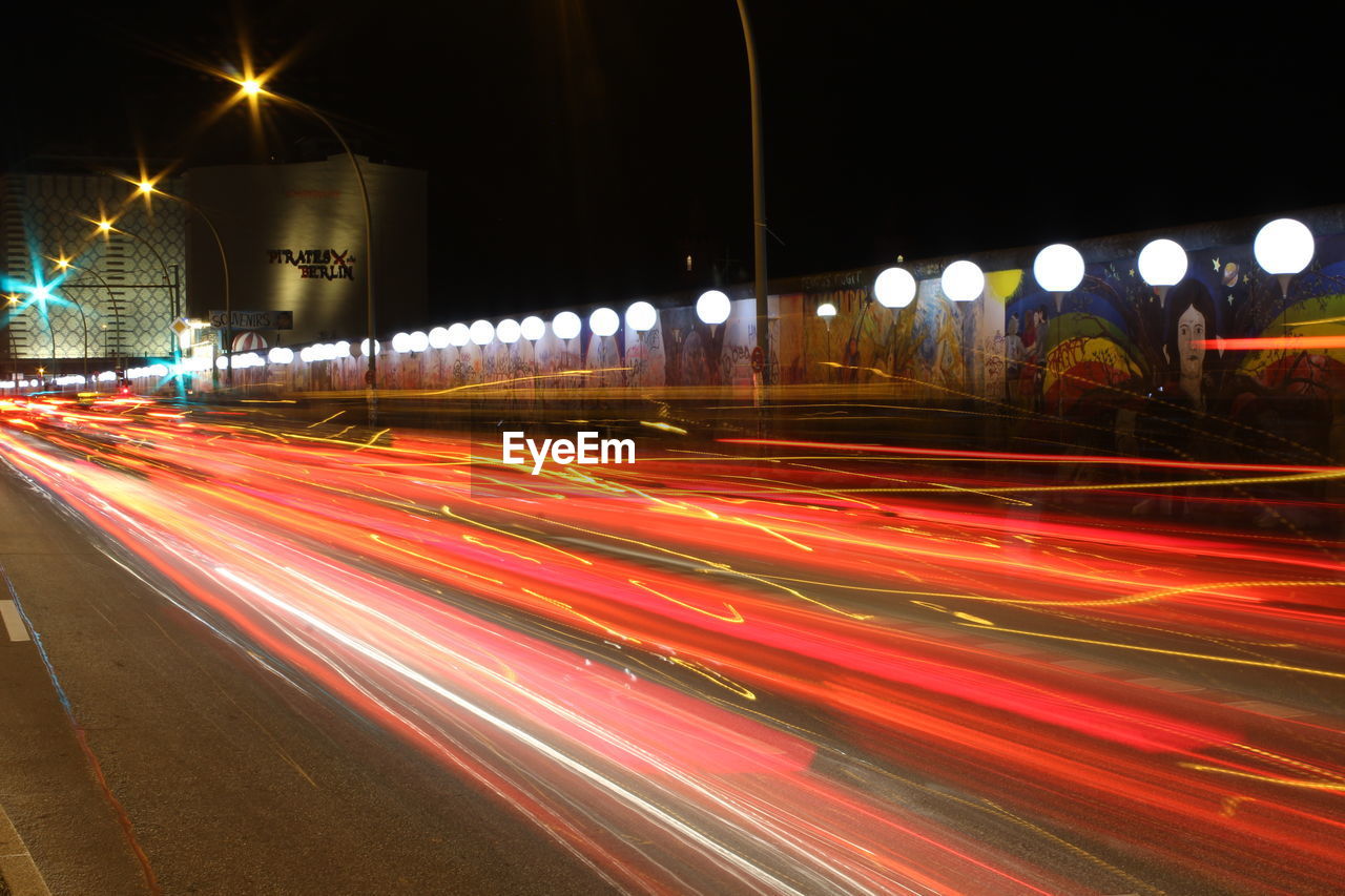 Light trails on illuminated city road at night