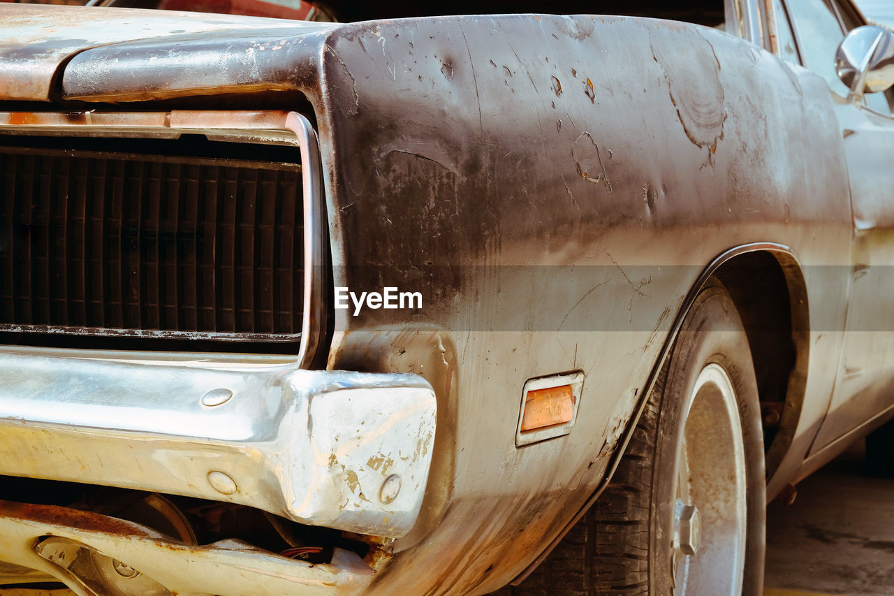 CLOSE-UP OF RUSTY CAR ON BUS