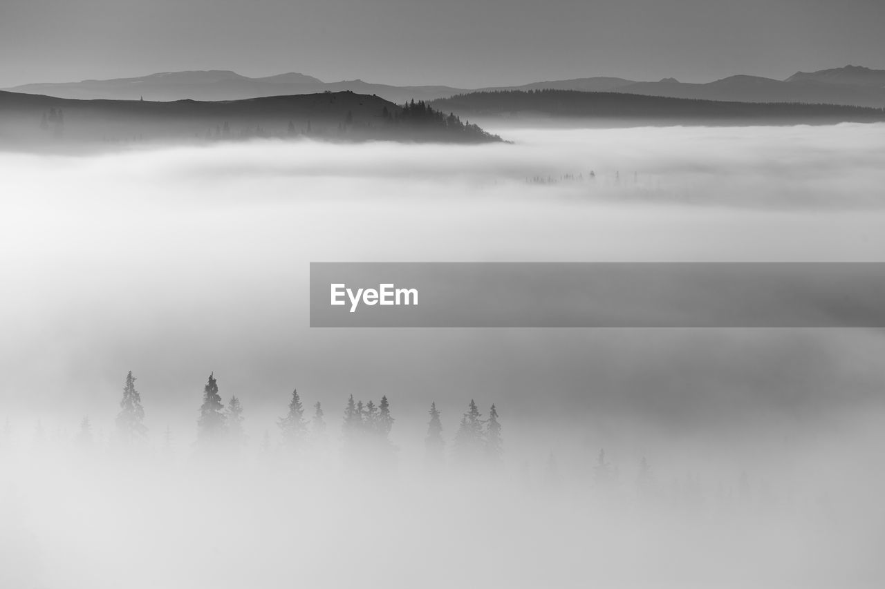 Scenic view of mountains in foggy weather