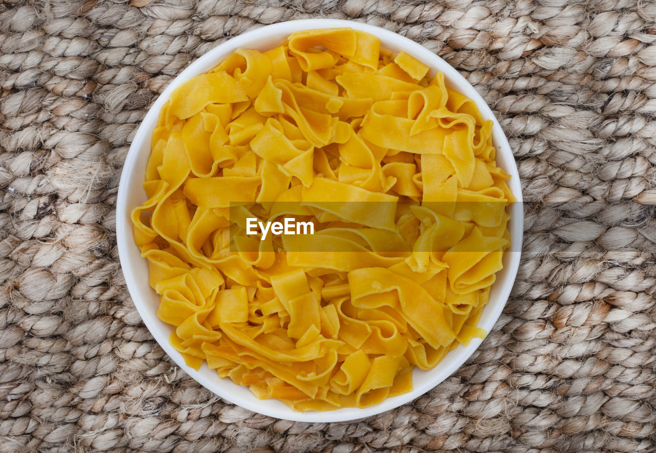 Bowl of cooked plain butternut pasta on rustic table