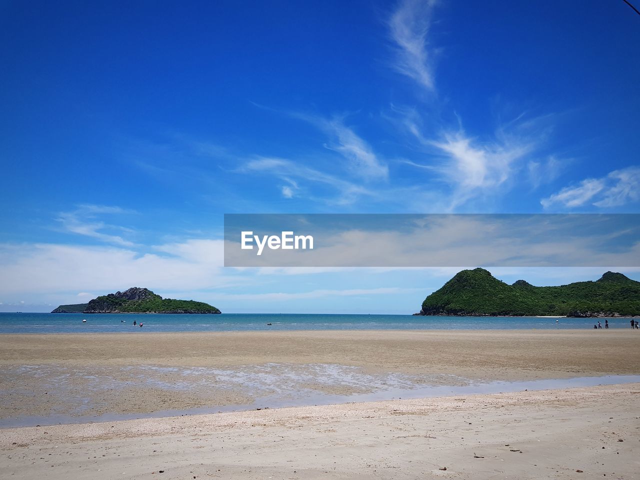 Scenic view of beach against blue sky