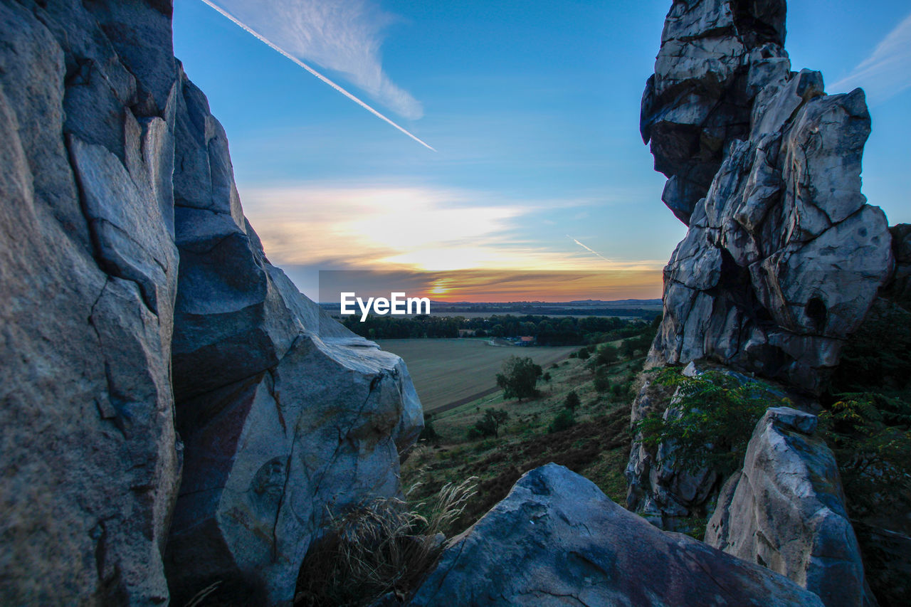 Scenic view of rock formation against sky during sunset