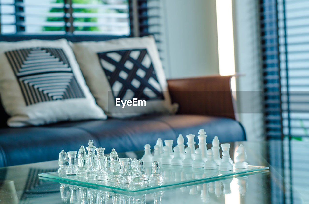 Close-up of chess pieces on board at home
