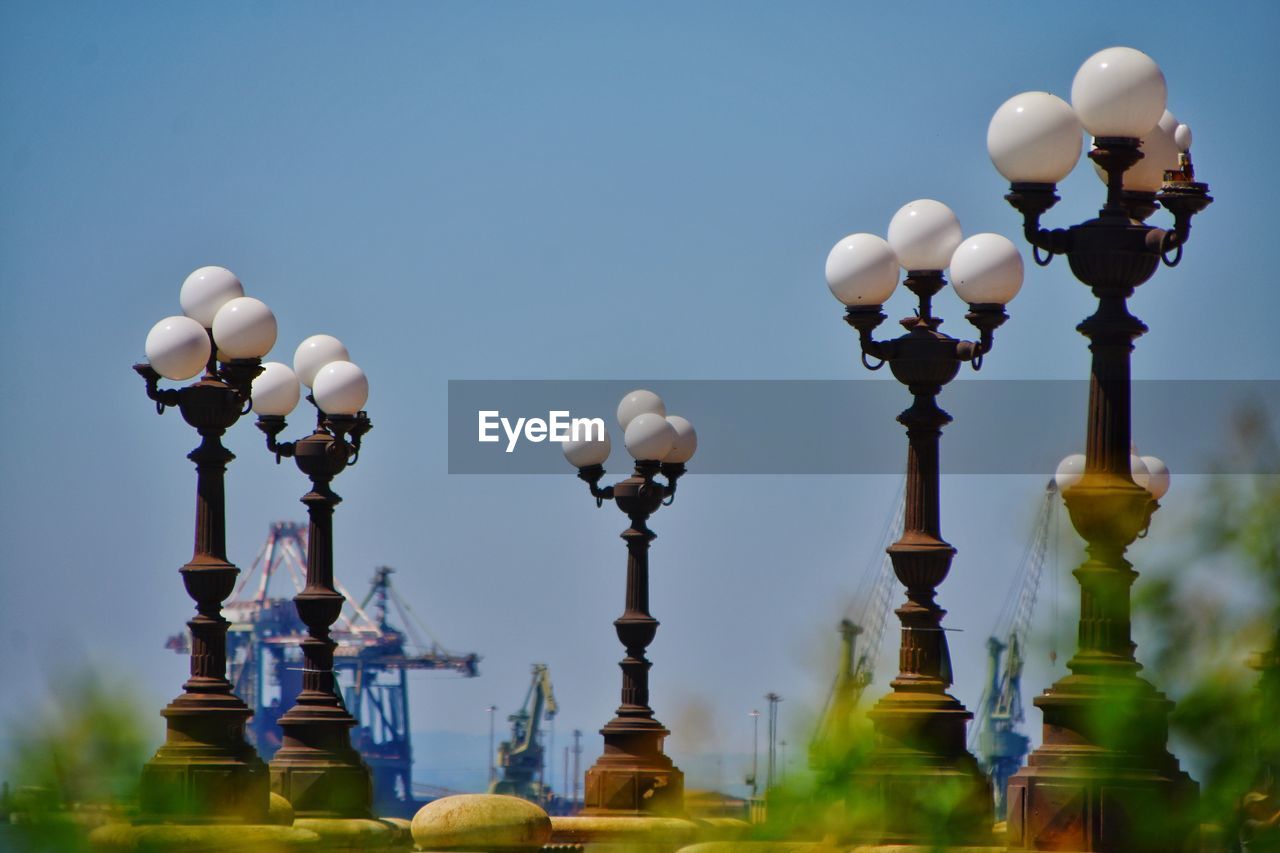 Low angle view of street lights against clear sky