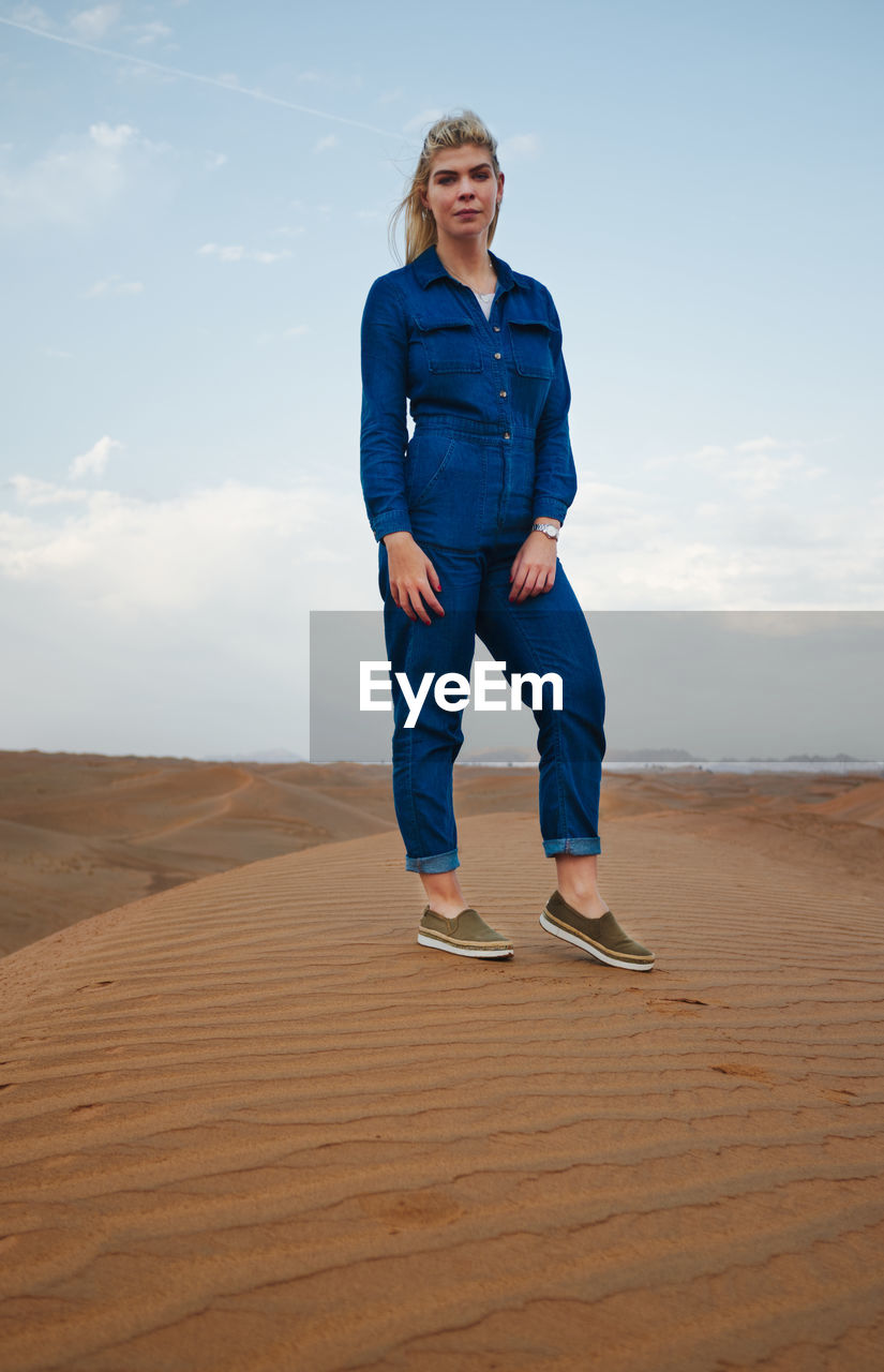 Full length of woman on sand dune