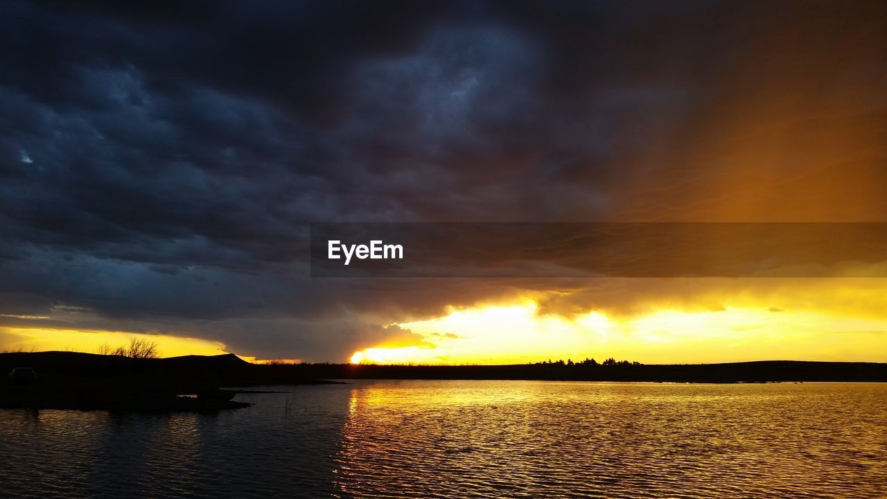 SCENIC VIEW OF SUNSET OVER LAKE