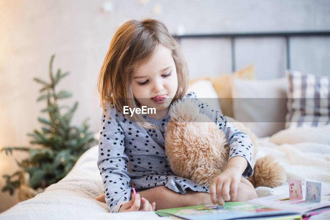 GIRL LOOKING AT CAMERA AT HOME