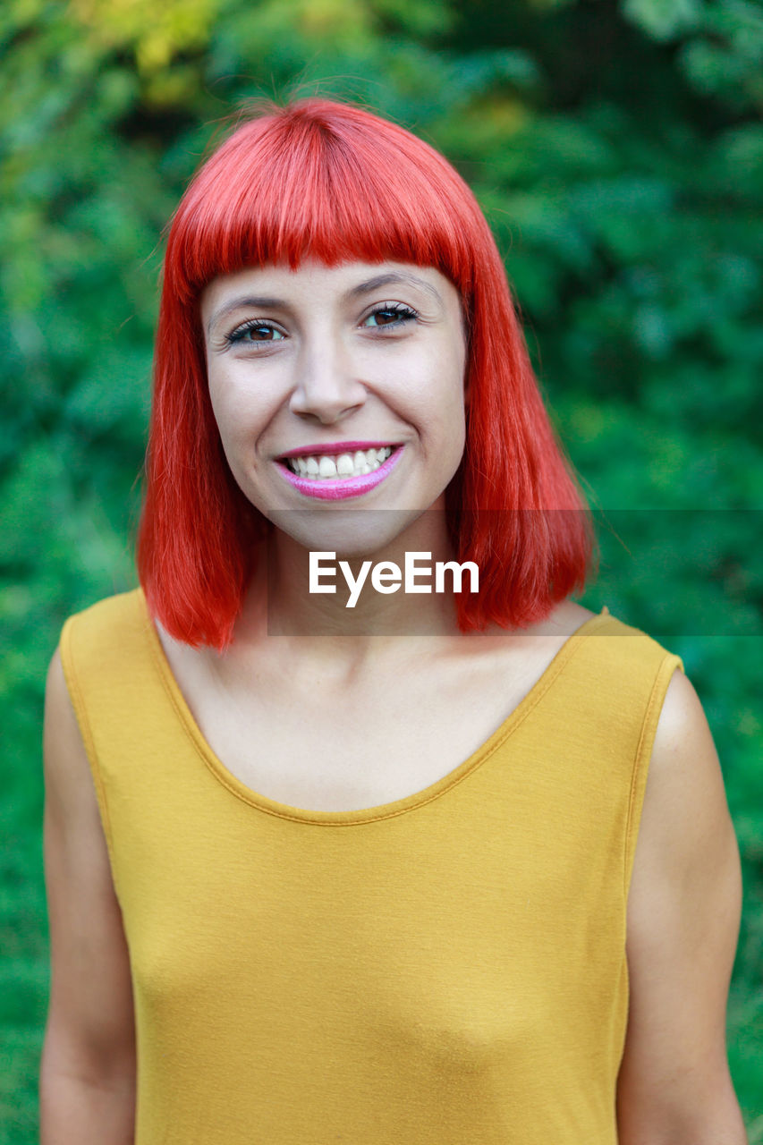 Portrait of smiling woman standing outdoors