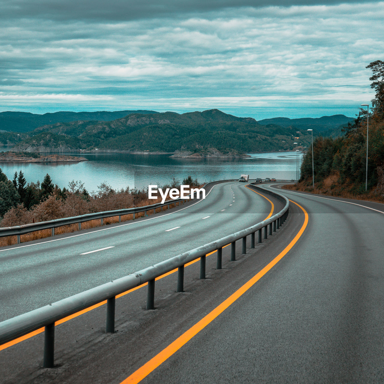 Road by mountain against sky