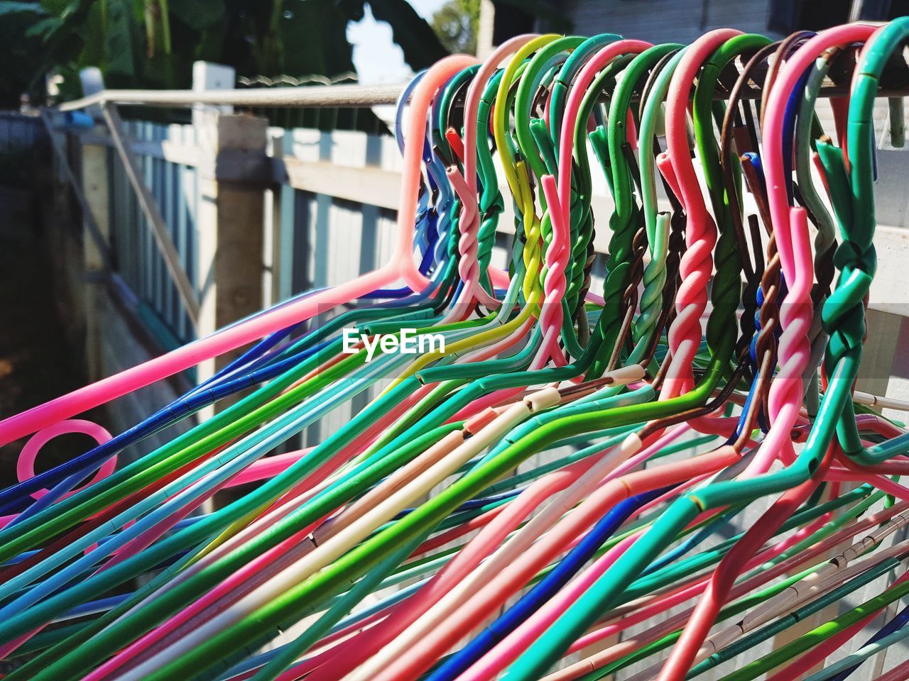 Close-up of multi colored coathangers hanging on rack