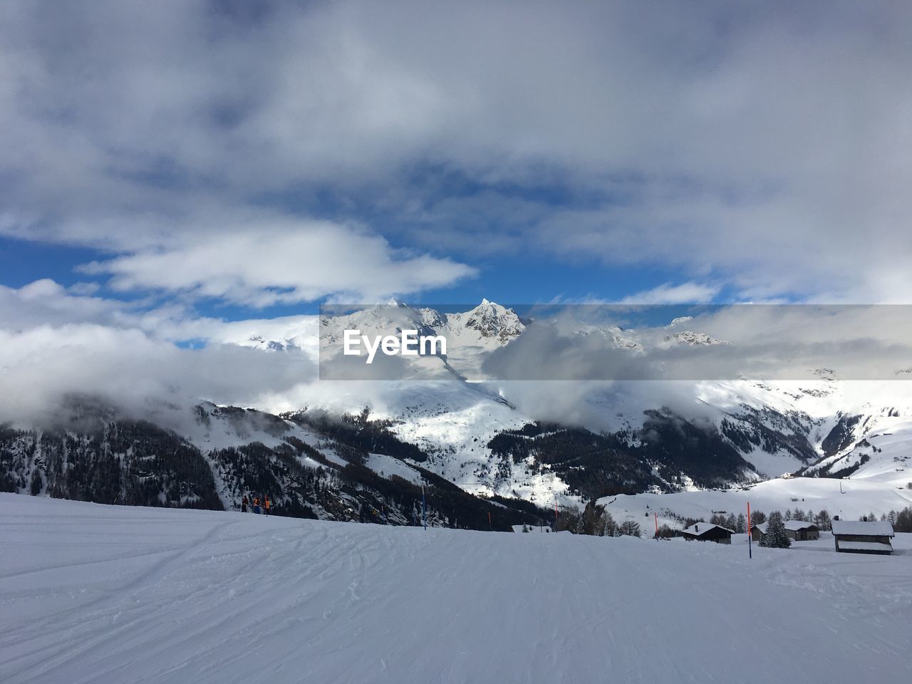 Scenic view of snowcapped mountains against cloudy sky