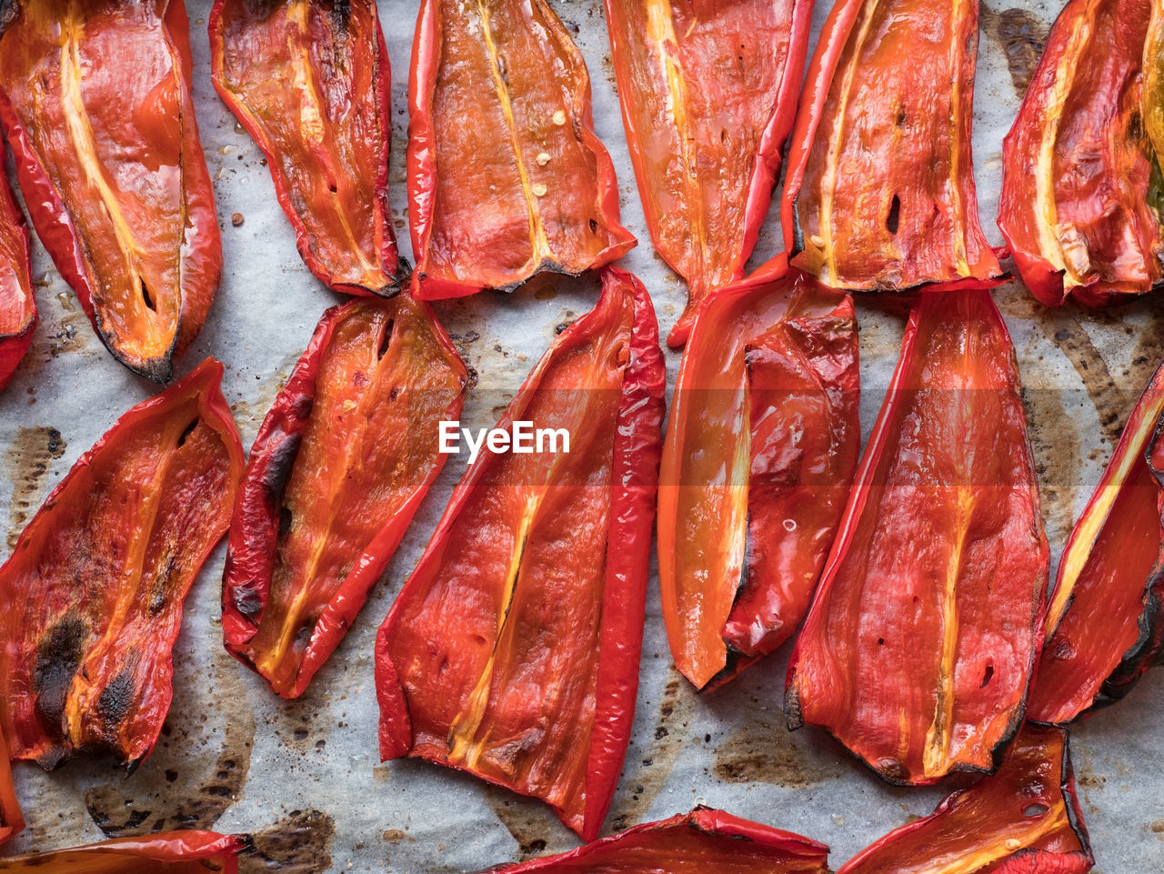 Close-up of roasted red peppers on baking paper