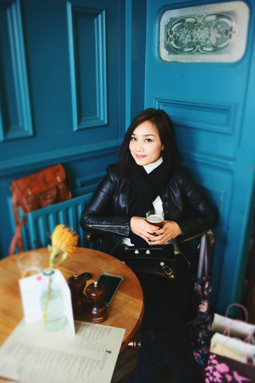 WOMAN SITTING IN RESTAURANT