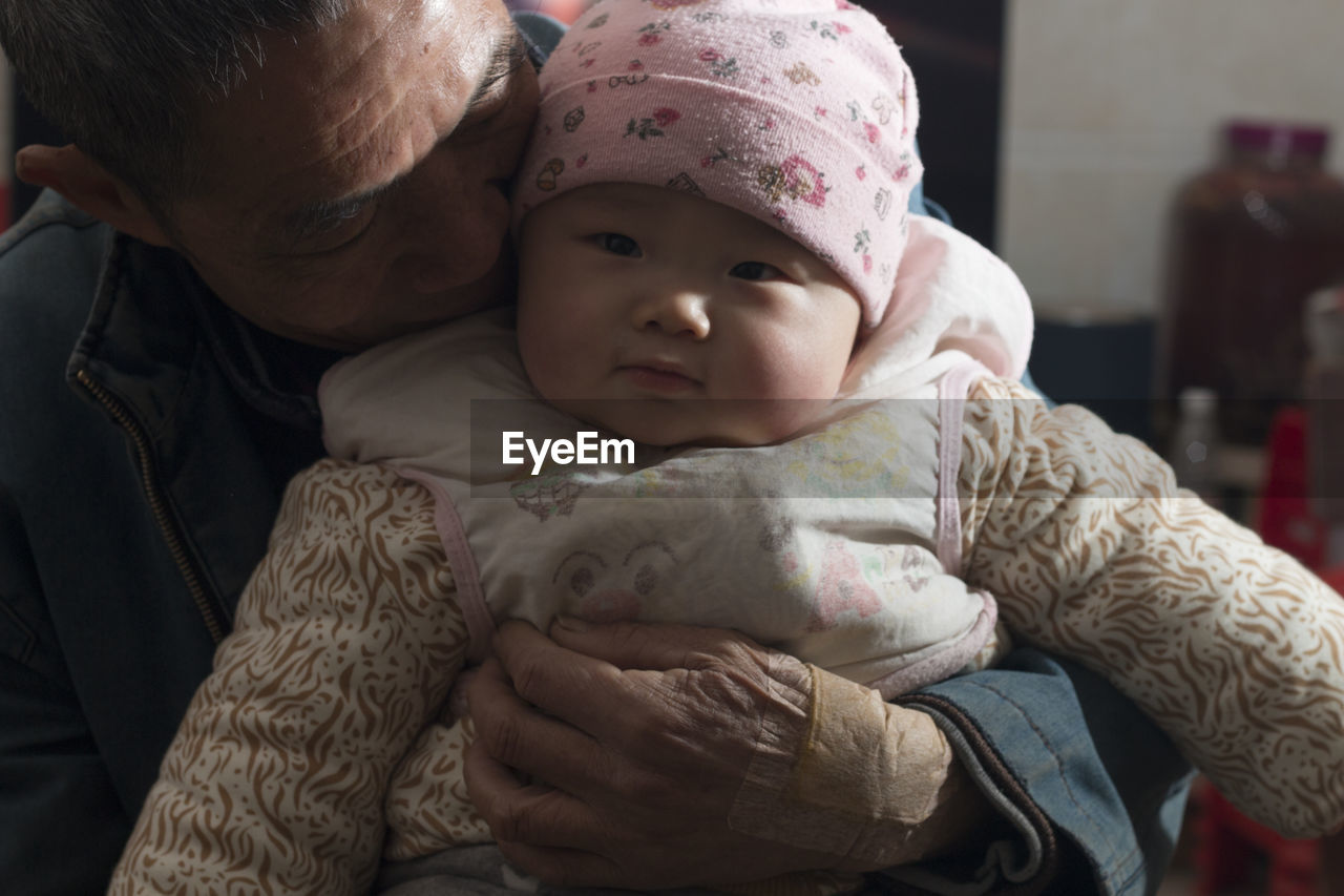 Portrait of cute baby boy with his grandfather