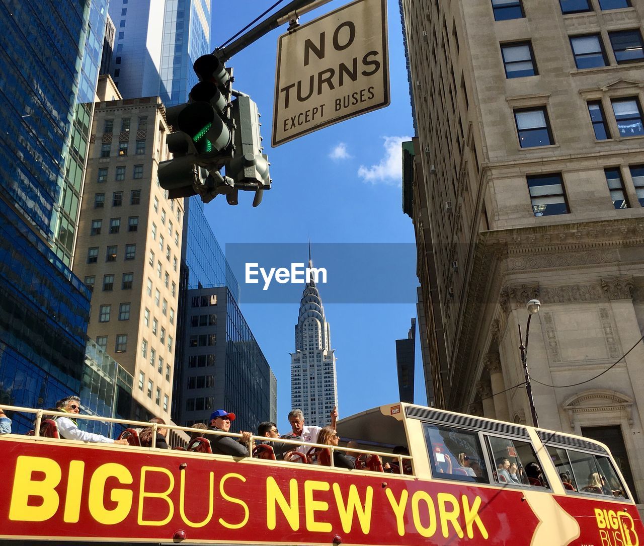 LOW ANGLE VIEW OF ROAD SIGN AGAINST BUILDINGS