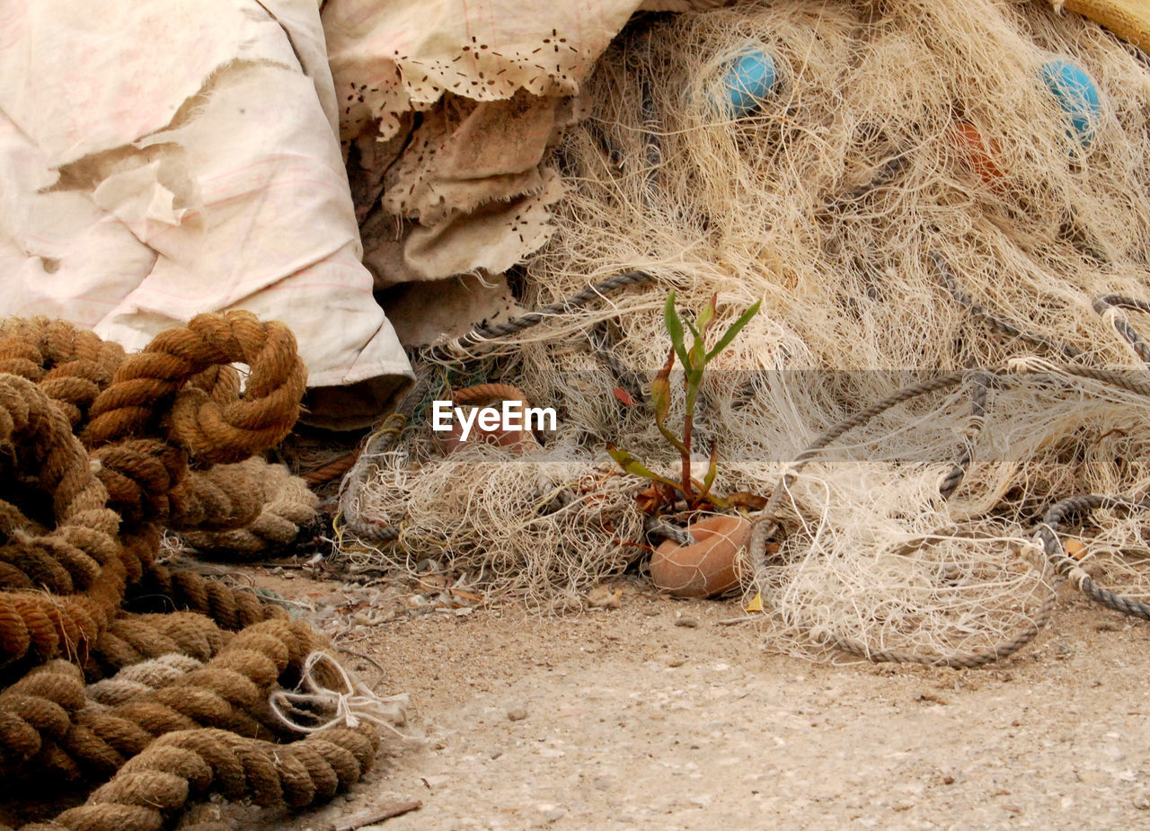 HIGH ANGLE VIEW OF FISHING NET ON LAND