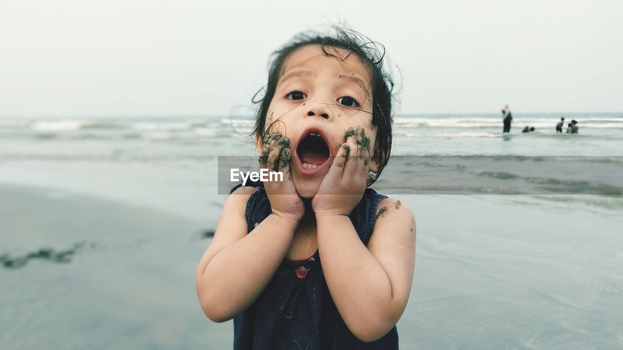 Portrait of shocked girl on beach