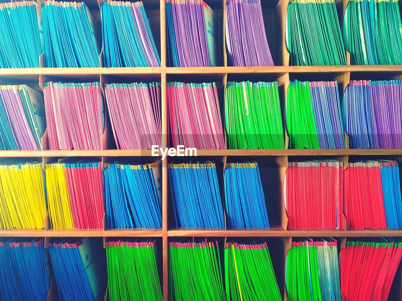 Full frame shot of multi colored files in shelves