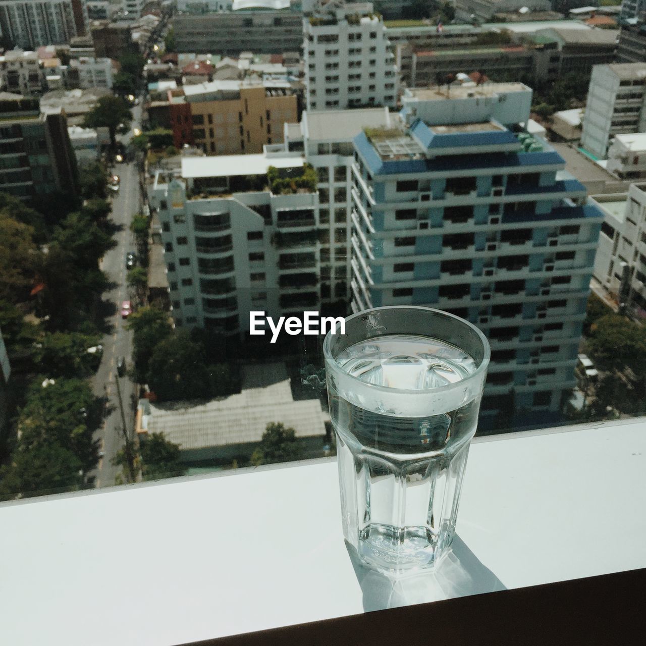 Close-up of drinking water glass on window sill