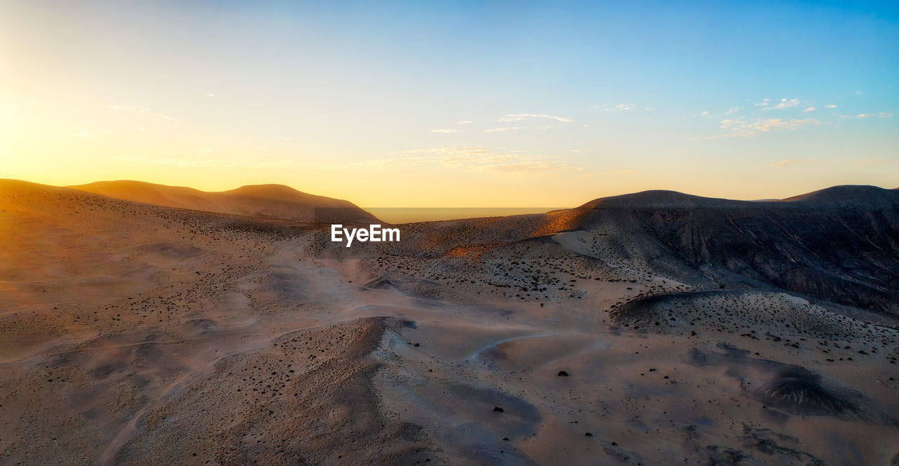 Scenic view of mountains against sky during sunset