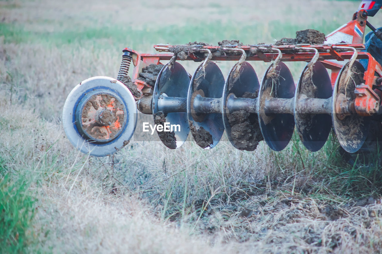 CLOSE-UP OF MACHINE IN FIELD