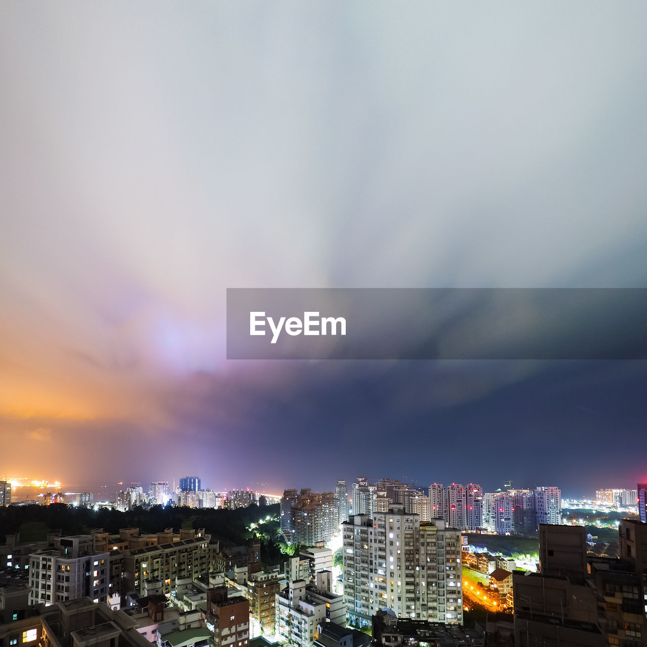 High angle view of illuminated buildings against sky at night