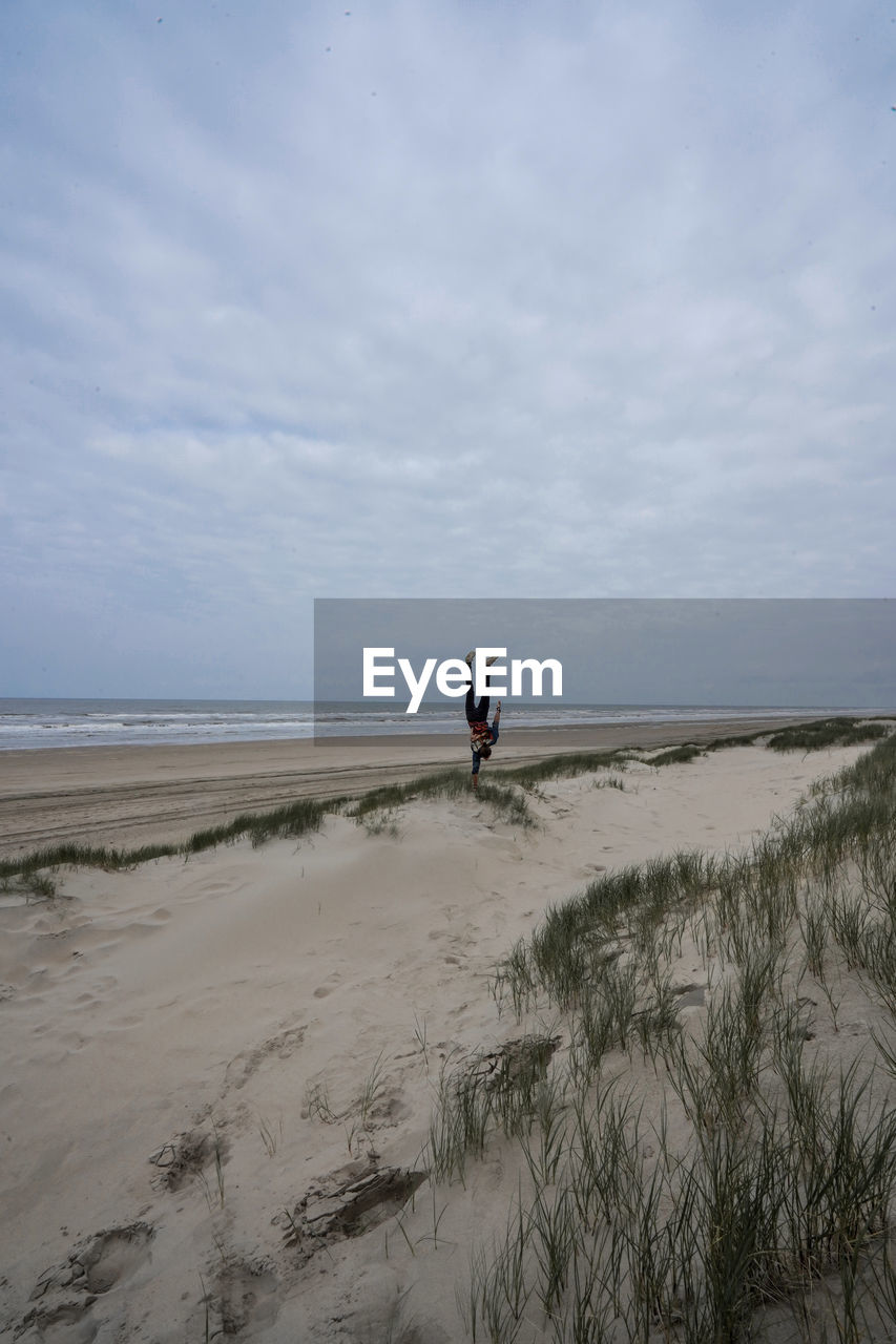 Handstand on a beach near the sea europe