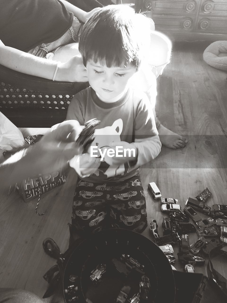 FULL LENGTH OF BOY SITTING ON CAMERA