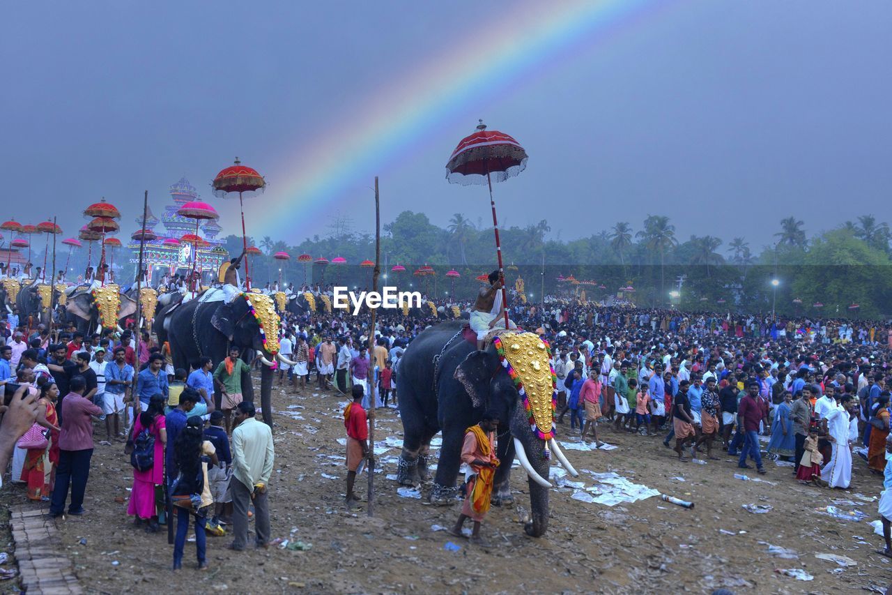 crowd, rainbow, large group of people, group of people, festival, event, sky, celebration, nature, arts culture and entertainment, men, multi colored, outdoors, performance, music festival, lifestyles