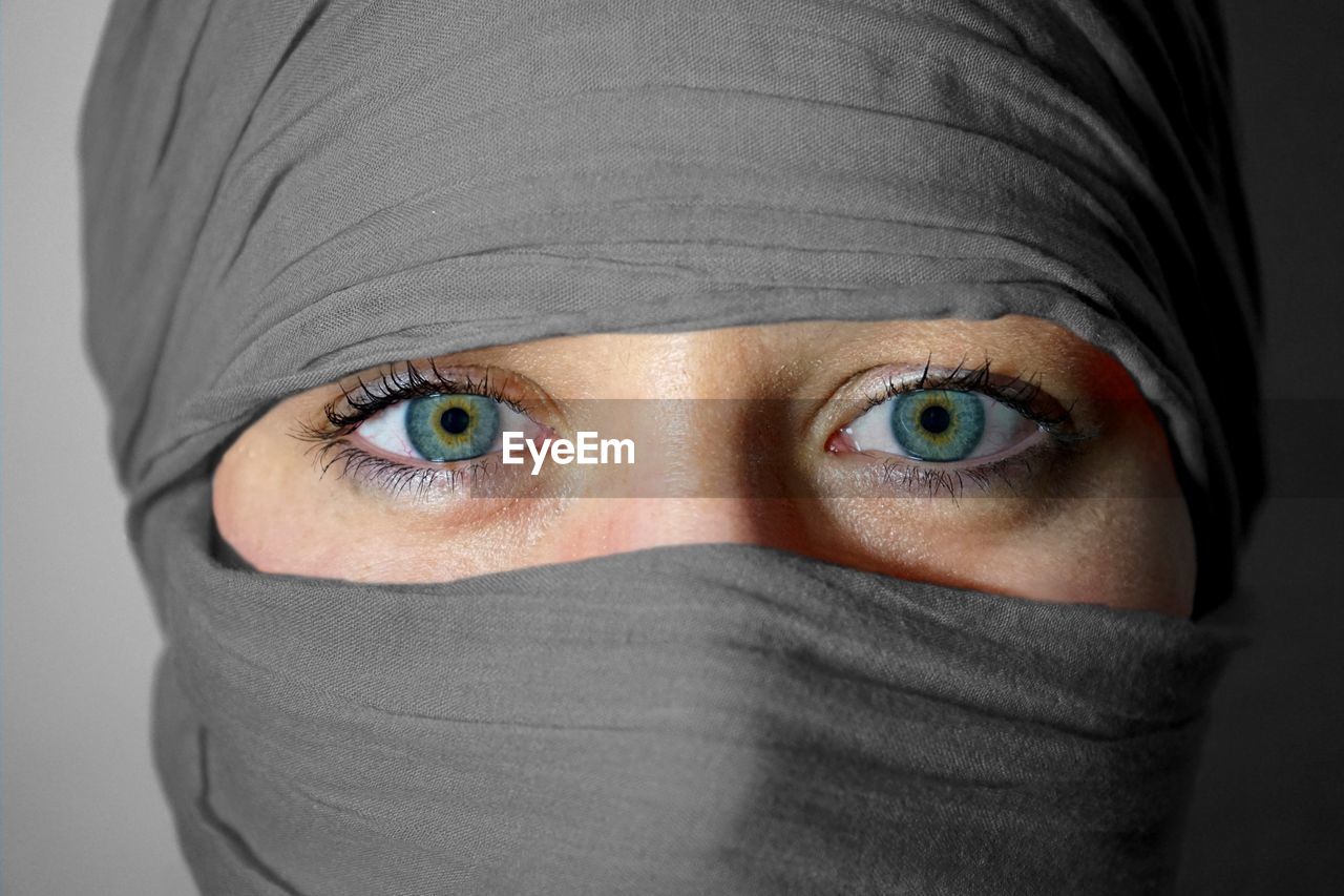 Close-up portrait of woman with face covered by scarf